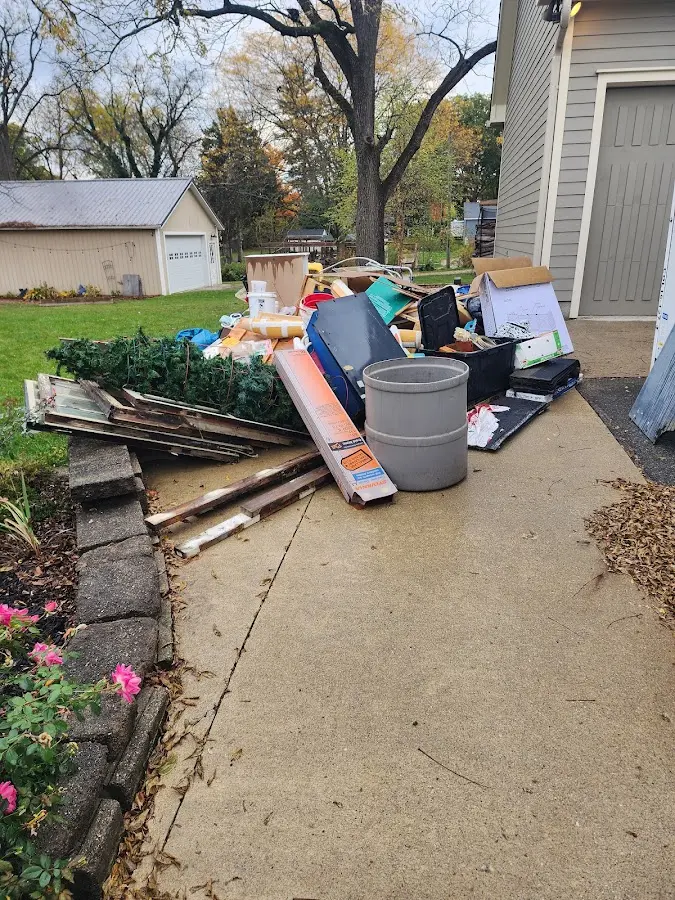 Dumpster being loaded with debris for Demolition Dumpster Rental in Loves Park